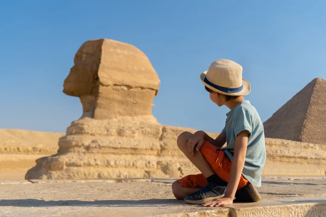 Child visitor near the Great Sphinx at Giza, Egypt